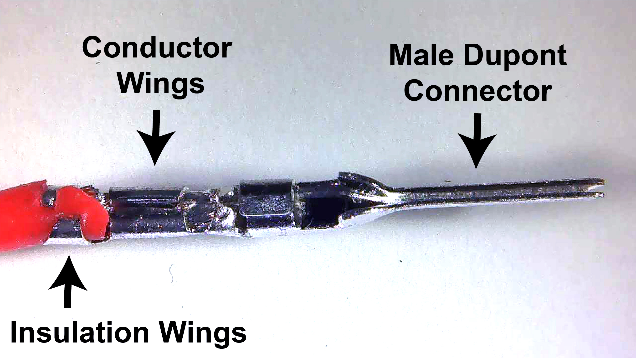 Close up of male dupont connector crimped onto a wire.