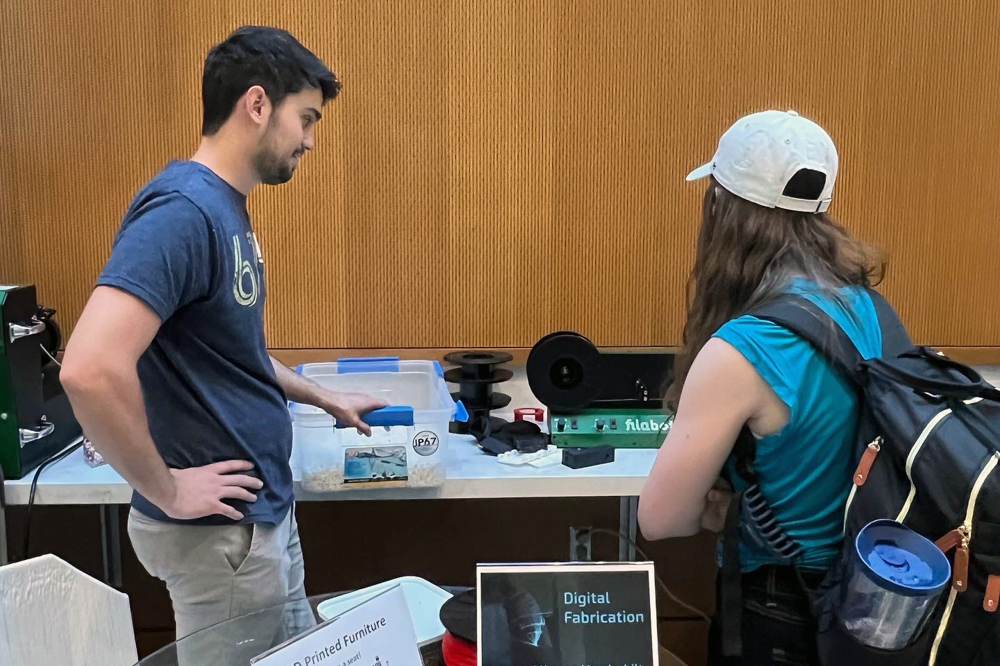 Dr. D-Flo explaining to a student how 3D printer filament is produced.